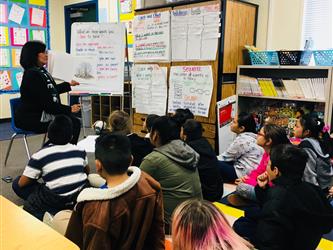 Superintendent Luna reading to students.